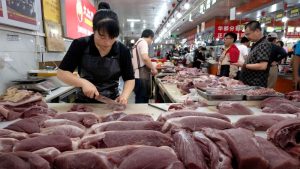Plunging pork prices tip China back into deflation