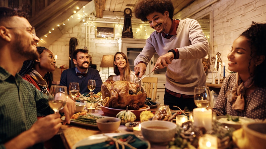 man carving turkey